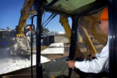 Doug Ness, then The Columbian's finance director, operates a backhoe to take one of the first "bites" of the former Jantzen swimwear factory in 2006. The Columbian bought the property, now the location of Grand Central Fred Meyer, with the intention of building an office, but later sold the site.