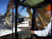 Doug Ness, then The Columbian's finance director, operates a backhoe to take one of the first "bites" of the former Jantzen swimwear factory in 2006. The Columbian bought the property, now the location of Grand Central Fred Meyer, with the intention of building an office, but later sold the site.