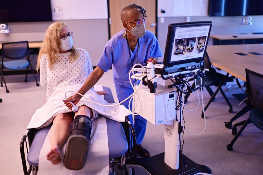 Standardized patients Susan Pierre, left, and Shelley McMillion are in a rehearsal with an ultra sounding system for a planned Simulation Education Project in the Equity multipurpose room of the University of Colorado Anschutz Medical Campus in Aurora, Colo.