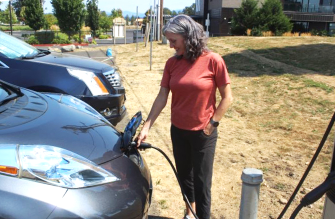 Port of Camas-Washougal Commissioner Cassi Marshall charges her electric vehicle (EV) at the Port's new EV charging station for the first time on Friday, Aug. 19, 2022.