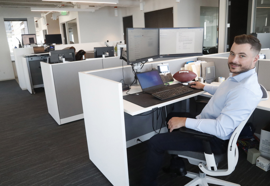Colton Teglovic at his desk at Savills in downtown Seattle.