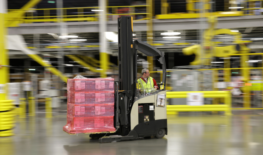 FILE - in this Feb. 13, 2015 file photo, a forklift operator moves a pallet of goods at a Amazon.com fulfillment center in DuPont, Wash. An Illinois corporate tax credit program suspended earlier this summer amid a state budget crisis has since been offered to Amazon because of a previous commitment to the online retailer. Amazon announced its plans in August for a Joliet warehouse that will create 1,000 full-time jobs when it opens. The 500,000-square-foot fulfillment center is its first in Illinois. (AP Photo/Ted S.