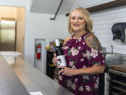 Owner Stacey Medak stands behind the bar for a portrait Friday at Cork & Bubbles, an upcoming champagne and wine bar in Felida.
