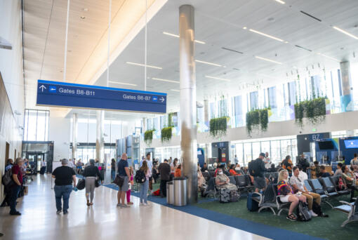 Travelers wait at their gates in the newly renovated and extended Concourse B, which reopened in late 2021 at Portland International Airport. PDX's new main terminal is under construction now and on track to open in 2025.