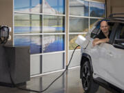 Andrew McLean, CEO of Invest.Green, takes a break with a 2022 Toyota RAV4 Prime plug-in hybrid at McCord's Vancouver Toyota on Monday. McLean launched an investment research company, aimed at educating investors about opportunities in backing green companies.