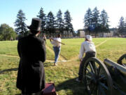 Present-day re-enactors at the Fort Vancouver National Historic Site demonstrate how "base ball" was played in the early days. Firing the cannon started the ball game. Game regulations before 1900 had odd attributes. Walks counted as hits in 1877. Pitchers threw underhand. A bat could be of any length the striker (batter) wanted. Between 1885 and 1893, one side of the bat could be flat. The balls were soft, so gloveless players caught them. For a time after 1900, teams selected umpires from the crowd before the first pitch.
