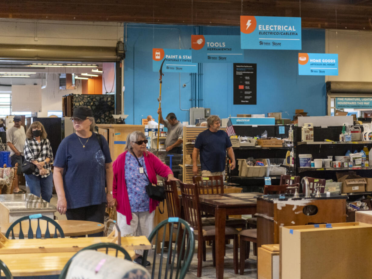 Shoppers browse the Clark County Habitat for Humanity Store during its grand reopening Friday.