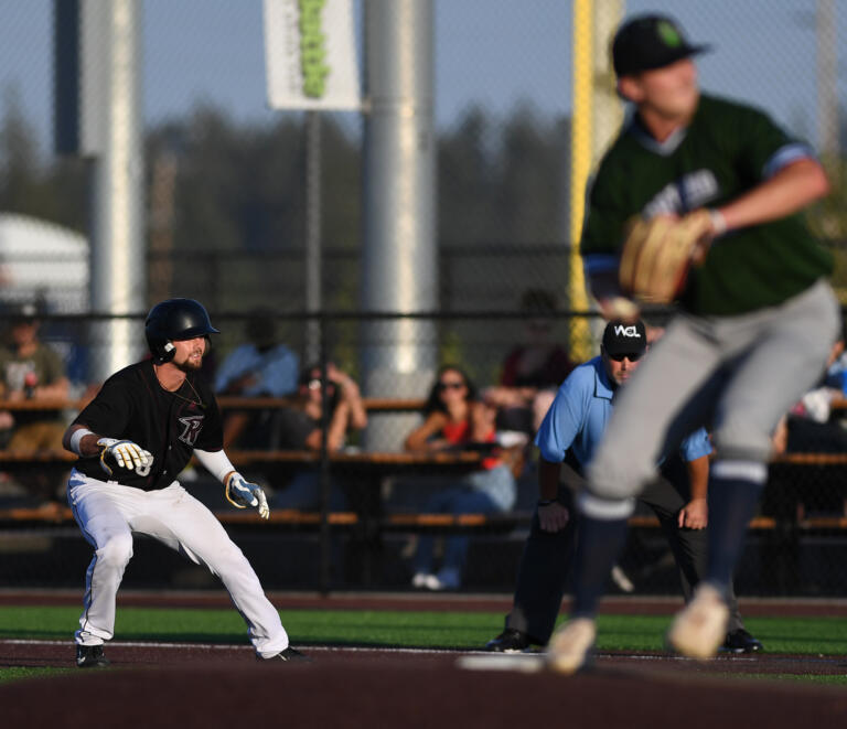 Raptors outfielder Trent Prokes, left, inches toward second base Tuesday, Aug. 9, 2022, during a playoff game between Ridgefield and the Portland Pickles at the Ridgefield Outdoor Recreation Complex.