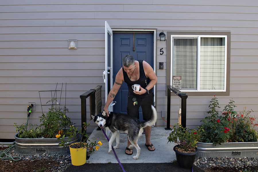 Fruit Valley Terrace resident Ty Wilson enjoys a playful moment with his dog, Apollo. Community Roots Collaborative, the nonprofit that created Fruit Valley Terrace, a tiny home village for people exiting homelessness, has partnered with Amerigroup Washington. Together, the two organizations plan to innovate solutions and collaborate on efforts that help people experiencing homelessness in Southwest Washington overcome barriers to resources.