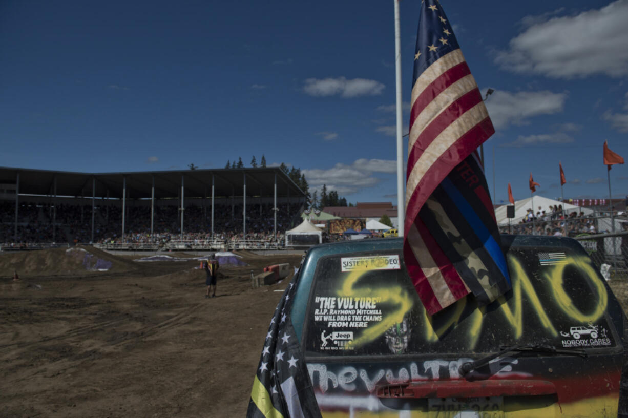 MGAS Motorsports Tuff Truck annual race at the Clark County Fair claims a new series of auto-victims as amateurs race their trucks around a bumpy course. A Centennial American flag attached to a truck getting ready to race.