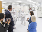 U.S. Sens. Maria Cantwell and Patty Murray talk with nLight employees with CEO Scott Keeney, left, on Wednesday in a clean room at nLight in Camas. Senators Cantwell and Murray were in town to tout the major opportunities coming to Southwest Washington in the recently passed $250 billion CHIPS and Science Act.