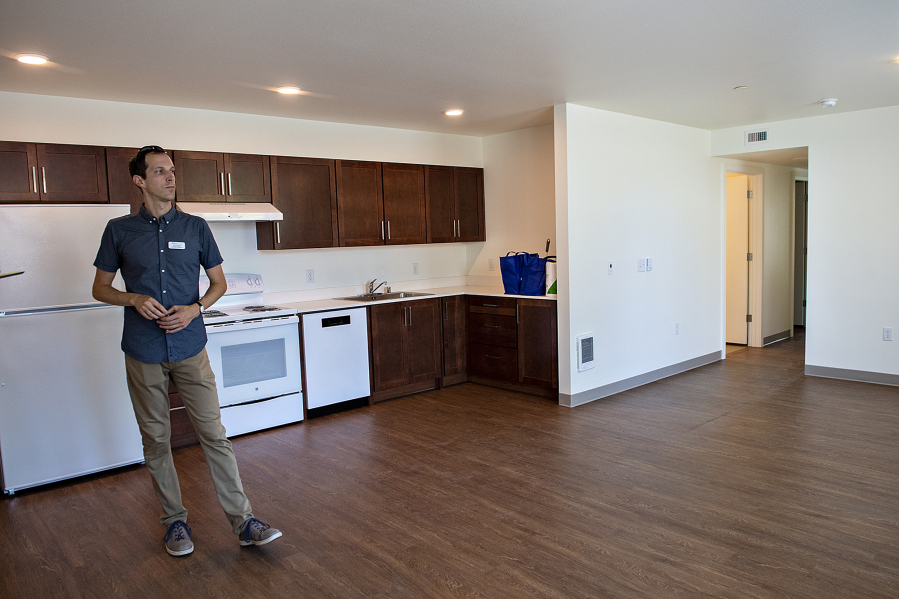 Chris Bendix, project developer for Mercy Housing, looks over a three-bedroom unit at the new Columbia Heights affordable housing complex. The project, which offers 69 affordable homes, celebrated its grand opening on Wednesday.