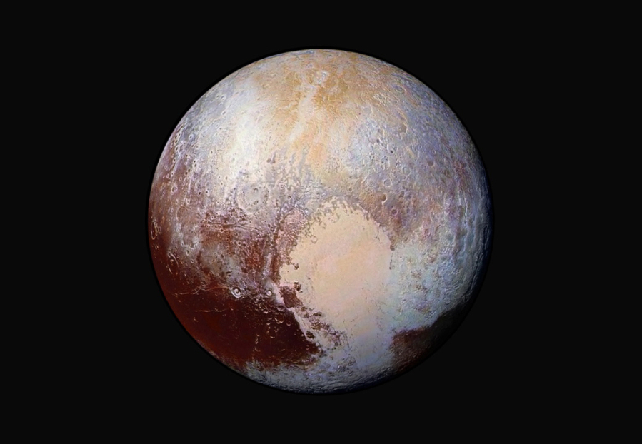 NASA/JHUAPL/SwRI via AP
This image made available by NASA on July 24, 2015, shows a combination of images captured by the New Horizons spacecraft with enhanced colors to show differences in the composition and texture of Pluto's surface. The deep icy basin in Pluto's heart-shaped region may be a natural sinkhole.