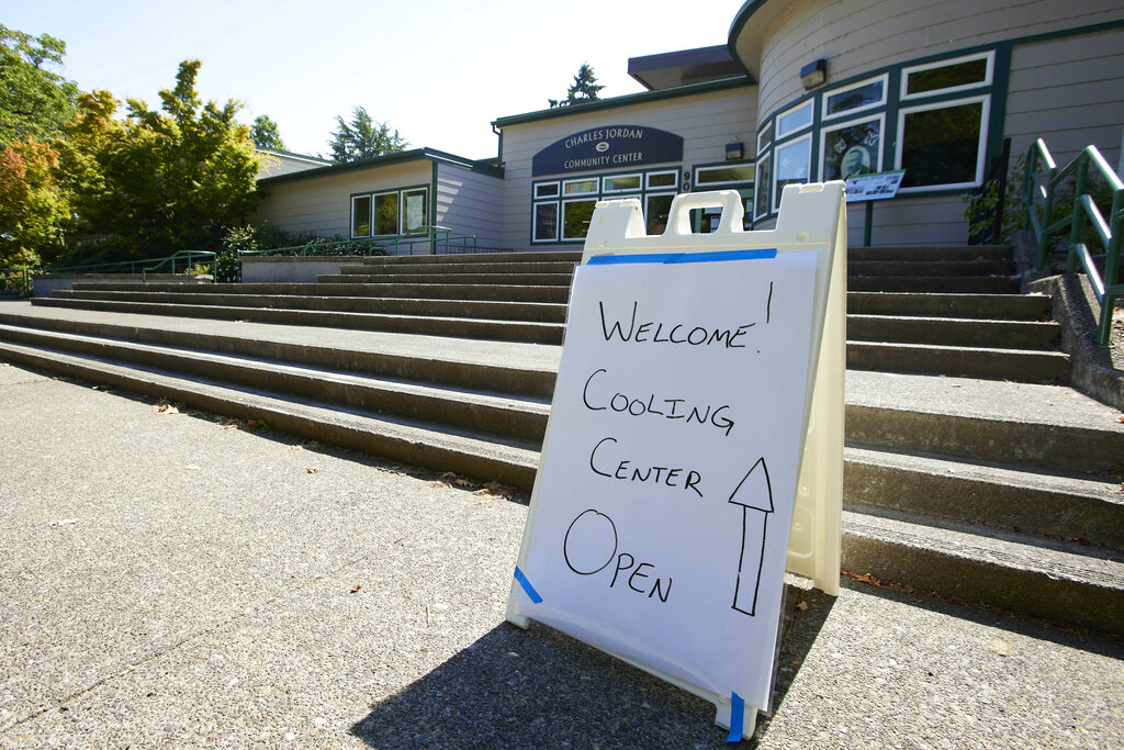 A sign showing that a cooling center at the Charles Jordan Community Center is open is shown in Portland on July 26. Temperatures are expected to top 100 degrees on Tuesday and wide swaths of western Oregon and Washington are predicted to be well above historic averages throughout the week.