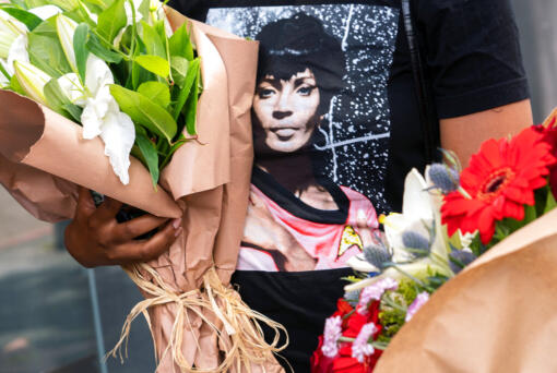 Fan Desirae Rogers brings Resurrection lilies to honor actor Nichelle Nichols on her Hollywood Walk of Fame star in Los Angeles, Monday, Aug.1, 2022. Nichols, who broke barriers for Black women in Hollywood as communications officer Lt. Uhura on the original "Star Trek" television series, has died at the age of 89.