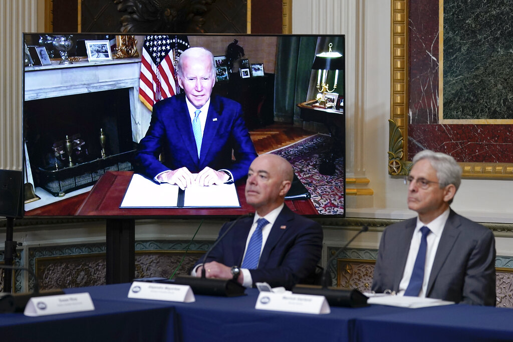 Homeland Security Secretary Alejandro Mayorkas and Attorney General Merrick Garland, right, listen as President Joe Biden speaks virtually during the first meeting of the interagency Task Force on Reproductive Healthcare Access in the Indian Treaty Room in the Eisenhower Executive Office Building on the White House Campus in Washington, Wednesday, Aug. 3, 2022.