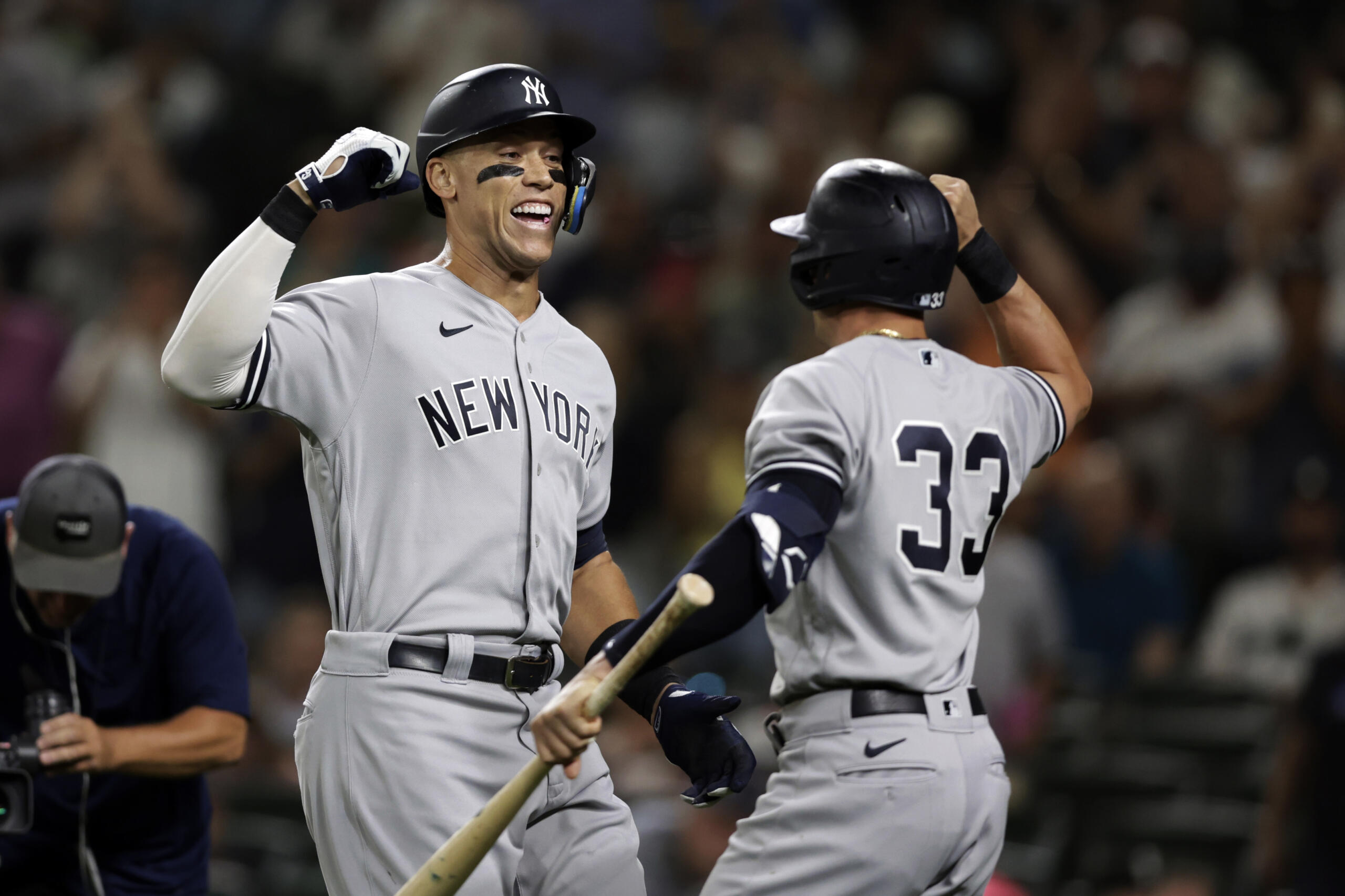 New York Yankees' Aaron Judge celebrates with Tim Locastro after hitting a solo home run on a pitch from Seattle Mariners' Ryan Borucki during the ninth inning of a baseball game, Monday, Aug. 8, 2022, in Seattle.