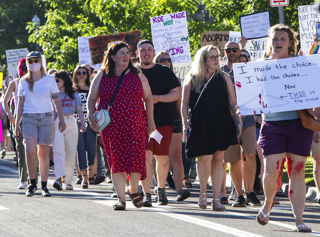 FILE - Protestors march through downtown Boise chanting pro-abortion rights slogans on their way to the Idaho Capitol steps, June 24, 2022 in Boise. The U.S. Department of Justice asked a federal judge this week to bar Idaho from enforcing its near-total abortion ban while a lawsuit pitting federal health care law against state anti-abortion legislation is underway.