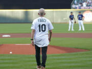 Dr. Anthony Fauci walks to the mound to throw out the first pitch before a baseball game between the Seattle Mariners and the New York Yankees, Tuesday, Aug. 9, 2022, in Seattle. Fauci is President Joe Biden's chief medical adviser and director of the National Institute of Allergy and Infectious Diseases. (AP Photo/Ted S.
