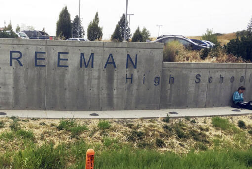 FILE - The sign for Freeman High School in Rockford, Wash., is seen outside the campus on Sept. 13, 2017. A man who shot one classmate to death and wounded three others five years ago in a Washington state high school, apologized to his victims before he was sentenced to 40 years in prison Friday, Aug. 19, 2022. Caleb Sharpe, who was 15 at the time of the 2017 shootings at Freeman High School, pleaded guilty earlier this year in Spokane County Superior Court. (AP Photo/Nicholas K.
