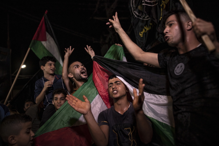 Palestinians celebrate the cease-fire agreement between Israel and Islamic Jihad Movement in Gaza City, early Monday, Aug. 8, 2022. A cease-fire deal to end nearly three days of fighting between Israel and Palestinian militants has held throughout the night, signaling the latest round of violence may have abated.