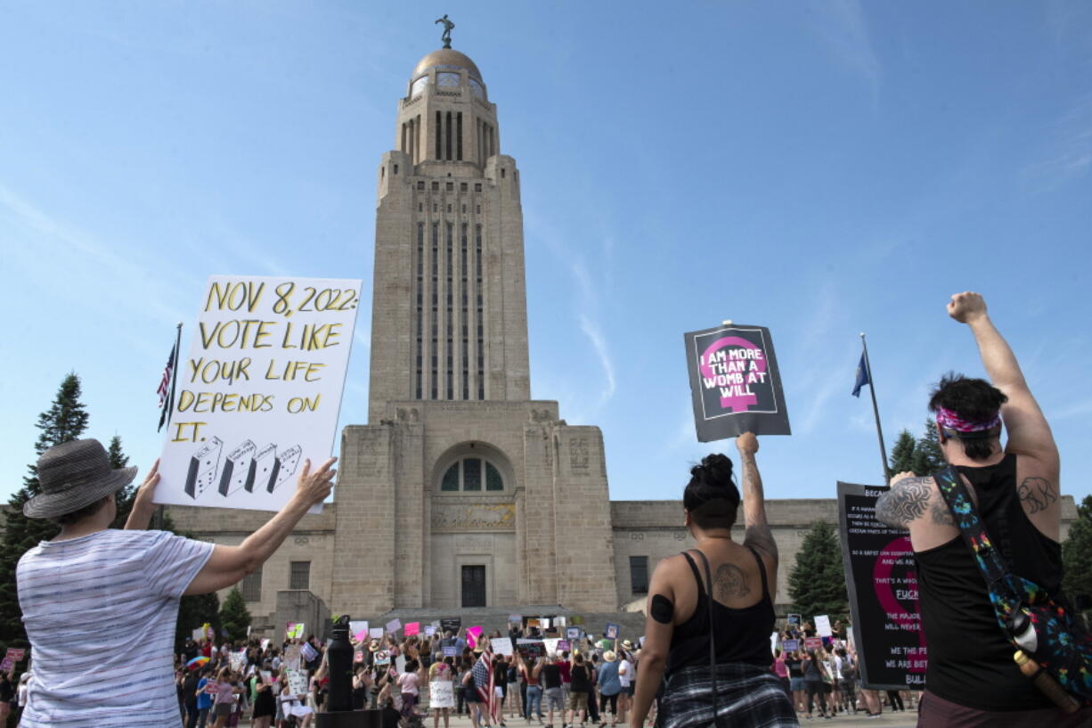 FILE - Protesters line the street around the front of the Nebraska State Capitol during an Abortion Rights Rally held on July 4, 2022, in Lincoln, Neb. A Nebraska woman has been charged in early June with helping her teenage daughter end her pregnancy at about 24 weeks after investigators uncovered Facebook messages in which the two discussed using medication to induce an abortion and plans to burn the fetus afterward.