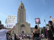 FILE - Protesters line the street around the front of the Nebraska State Capitol during an Abortion Rights Rally held on July 4, 2022, in Lincoln, Neb. A Nebraska woman has been charged in early June with helping her teenage daughter end her pregnancy at about 24 weeks after investigators uncovered Facebook messages in which the two discussed using medication to induce an abortion and plans to burn the fetus afterward.