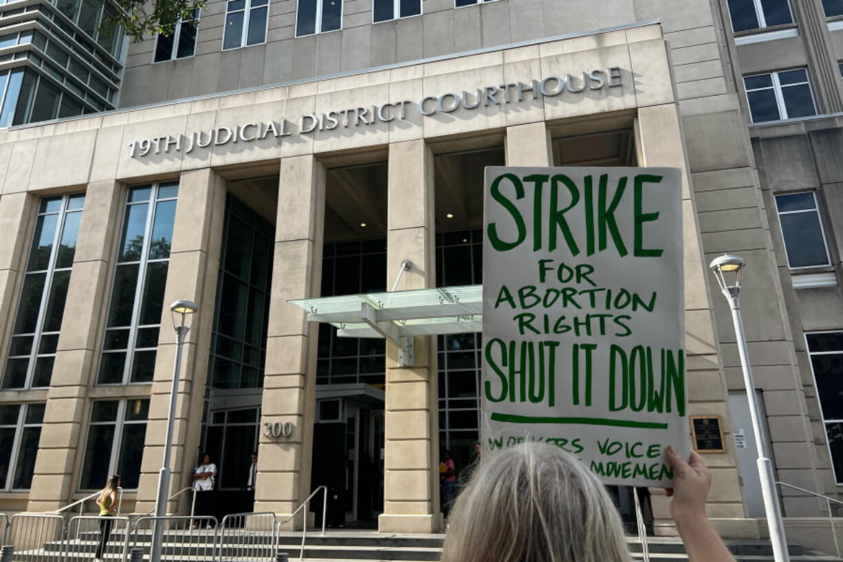 An abortion rights advocate demonstrates outside the 19th Judicial District Courthouse, Monday July 18, 2022, in Baton Rouge, La.