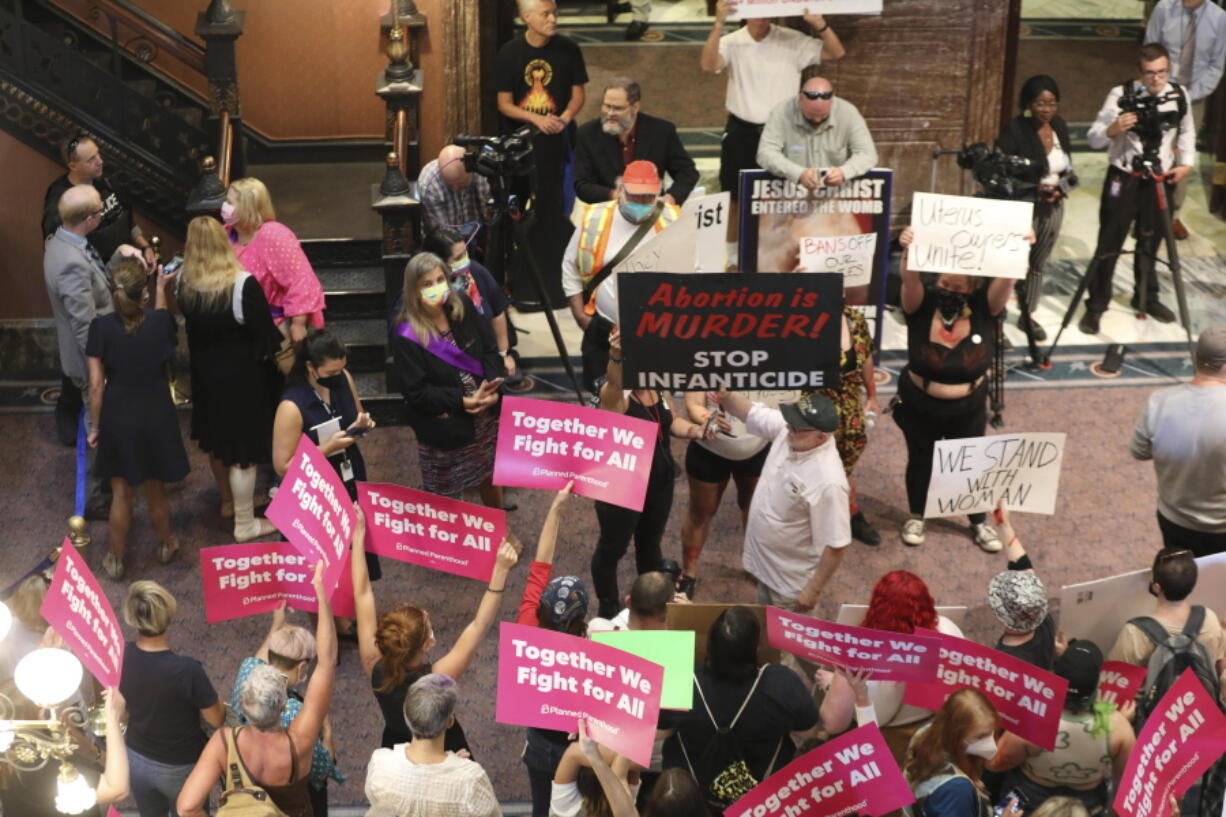 FILE - Protesters who support more abortion restrictions and protestors who upset at the recent U.S. Supreme Court ruling removing protections for abortions demonstrate in the lobby of the South Carolina Statehouse on June 28, 2022, in Columbia, S.C.  Some South Carolina lawmakers who oppose abortion are being cautious when it comes to tightening the state's already restrictive laws even further. The U.S. Supreme Court overturned Roe v. Wade in June, paving the way for states to enact total bans if they choose to do so.