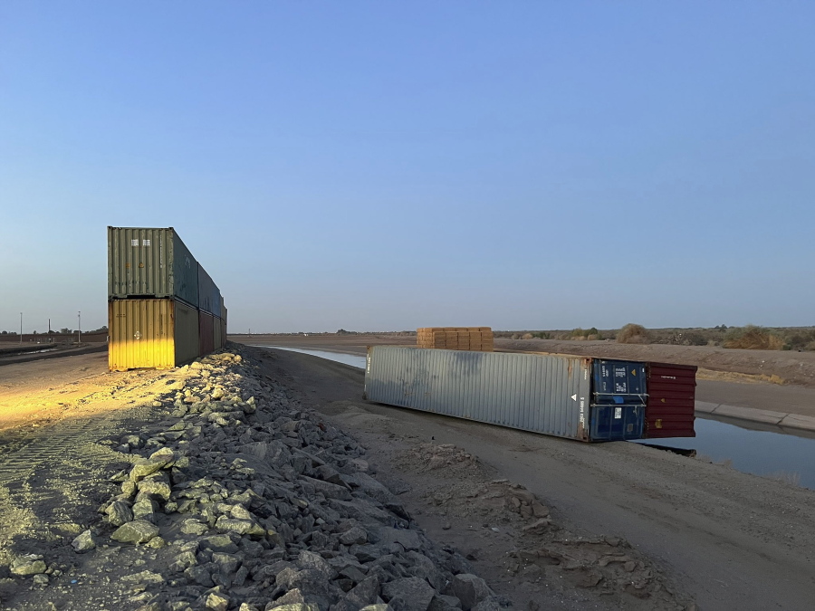 This photo provided of Univision Arizona shows empty shipping containers toppled over Sunday overnight on the Mexico-US international borderline in Yuma, Ariz., on Monday, Aug. 16, 2022.