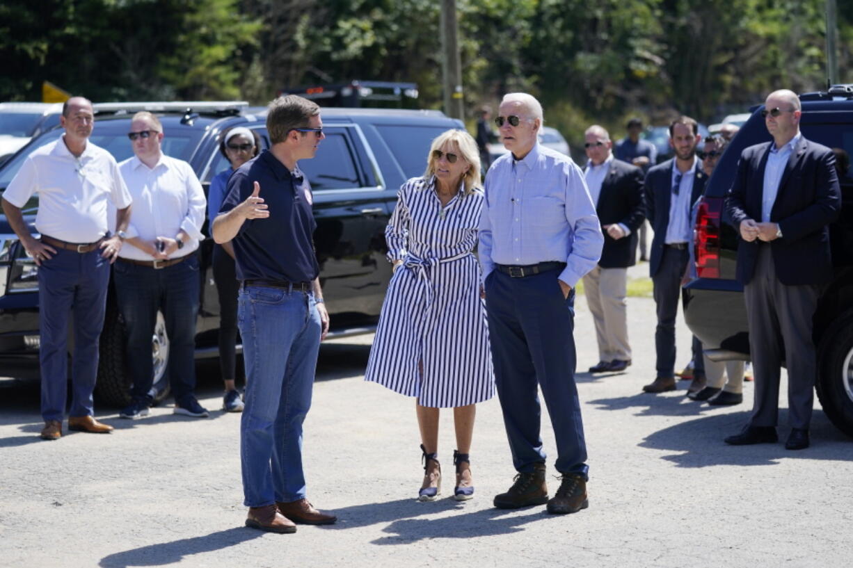 President Joe Biden and first lady Jill Biden, talk with Kentucky Gov. Andy Beshear, as they view flood damage, Monday, Aug. 8, 2022, in Lost Creek, Ky.