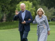 President Joe Biden with first lady Jill Biden waves as they walk on the South Lawn of the White House in Washington, upon arrival from a trip to visit flood affected areas in Kentucky, Monday, Aug. 8, 2022.