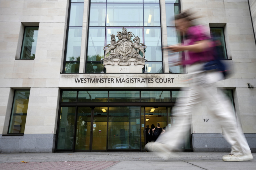 A Woman passes Westminster Magistrates Court in London, Wednesday, Aug. 17, 2022. A 20-year-old man has been charged with intending to injure or alarm The Queen under the Treason Act following an incident on Christmas Day 2021 at Windsor Castle. Jaswant Singh Chail was charged with an offence under section two of the Treason Act 1842 - last used more than 40 years ago - which is 'discharging or aiming firearms, or throwing or using any offensive matter or weapon, with intent to injure or alarm Her Majesty'.