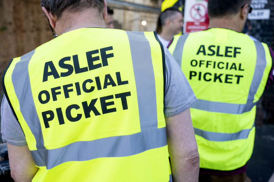 Aslef, Associated Society of Locomotive Engineers and Firemen members are pictured on a picket line at Willesden Junction station as members of the drivers union at nine train operators walk out for 24 hours over pay, in London, Saturday, Aug. 13, 2022.