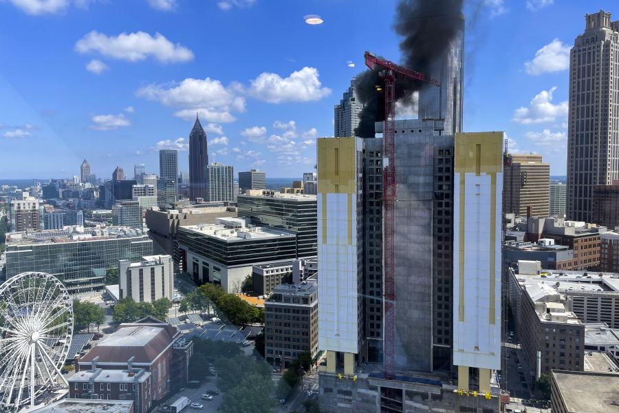 Smoke rises off a building under construction in downtown Atlanta on Wednesday, Aug. 31, 2022.