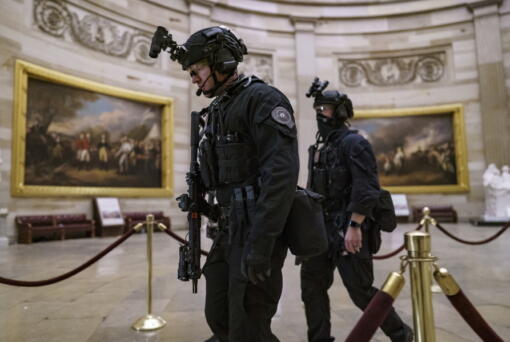 FILE - Members of the U.S. Secret Service Counter Assault Team walk through the Rotunda as they and other federal police forces responded as violent protesters loyal to President Donald Trump stormed the U.S. Capitol in Washington, Jan. 6, 2021. Top congressional Democrats are demanding that the Department of Homeland Security's inspector general hand over information on deleted Secret Service text messages related to the Jan. 6, 2012 attack on the Capitol, accusing him of using delay tactics to stonewall their investigation.  (AP Photo/J.