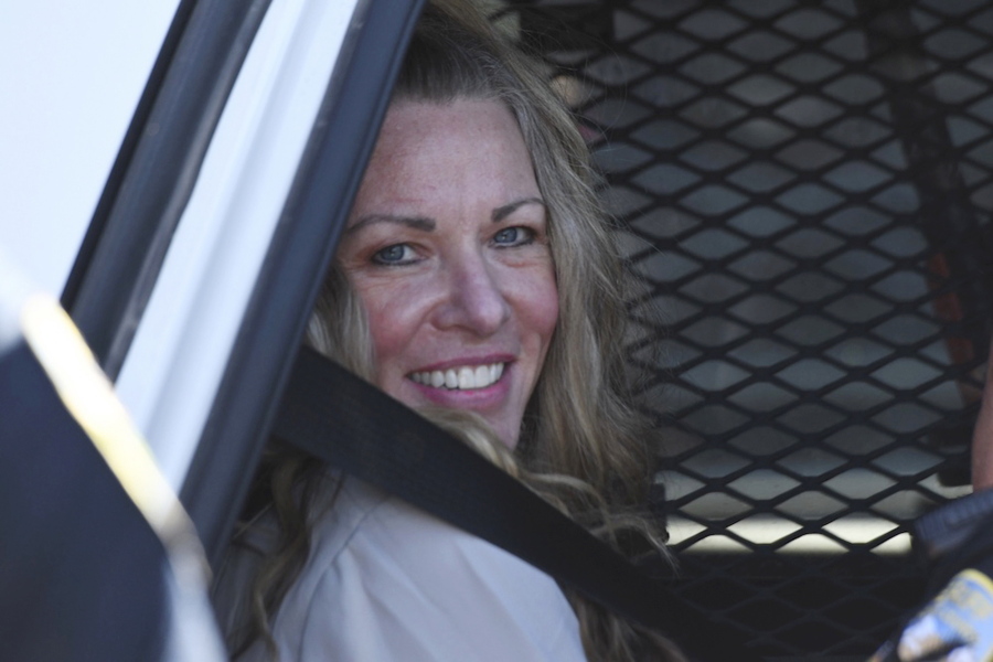 Lori Vallow Daybell sits in a police car after a hearing at the Fremont County Courthouse in St. Anthony, Idaho, Tuesday, Aug. 16, 2022. Attorneys for a mom charged with conspiring to kill her children and then steal their social security benefits asked a judge on Tuesday to send the case back to a grand jury because they say the current indictment is confusing. Lori Vallow Daybell and her husband Chad Daybell have pleaded not guilty and could face the death penalty if convicted.
