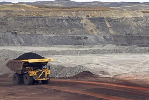 FILE - In this March 28, 2017 file photo, a dump truck hauls coal at Contura Energy's Eagle Butte Mine near Gillette, Wyo.  A judge has ruled U.S. government officials engaged in regional-level planning failed to follow a court order requiring them to consider allowing less coal to be mined as a way to fight climate change. The Wednesday, Aug. 3, 2022 ruling by U.S. District Judge Brian Morris in Great Falls, Montana, applies to the country's top coal-producing region, the Powder River Basin of Wyoming and Montana.