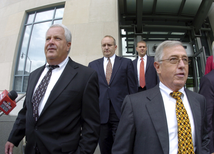 FILE - In this Tuesday, Sept., 15, 2009, file photo, former Luzerne County Court Judges Michael Conahan, front left, and Mark Ciavarella, front right, leave the United States District Courthouse in Scranton, Pa.  The two Pennsylvania judges who orchestrated a scheme to send children to for-profit jails in exchange for kickbacks were ordered to pay more than $200 million to hundreds of children who fell victim to their crimes.