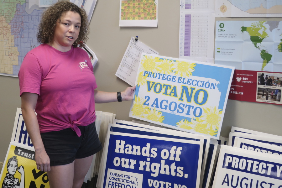Jessica Porter, communications chair for the Shawnee County, Kansas, Democratic Party, discusses a sign in Spanish urging voters to oppose a proposed amendment to the Kansas Constitution to allow legislators to further restrict or ban abortion, Friday, July 15, 2022, in Topeka, Kansas. The proposed amendment is a response to a 2019 Kansas Supreme Court decision protecting abortion rights.