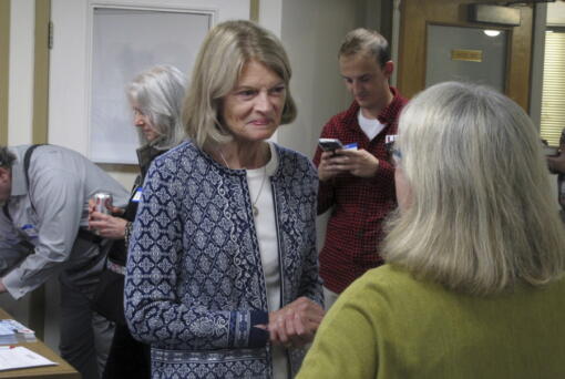 Alaska U.S. Sen. Lisa Murkowski, center, is shown at the grand opening of her reelection campaign office in Juneau, Alaska, on Thursday, Aug. 11, 2022. Murkowski said she expects to be among the candidates who will advance from the Aug. 16, 2022, U.S. Senate primary in Alaska. Under a system approved by voters and being used in Alaska for the first time this year, the top four vote-getters in the primary, regardless of party affiliation, will advance to the November general election, in which ranked voting will be used.
