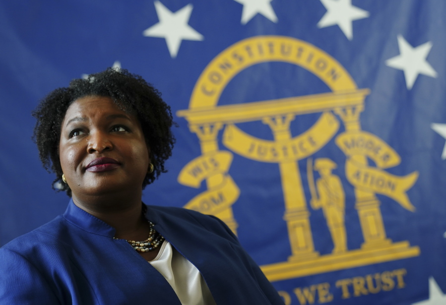 HOLD FOR STORY BY JEFF AMY EMBARGOED UNTIL 06:00 AM EST Aug. 9, 2020**Democratic candidate for Georgia Governor Stacey Abrams poses for a portrait in front of the State Seal of Georgia Monday, Aug. 8, 2022, in Decatur, Ga.