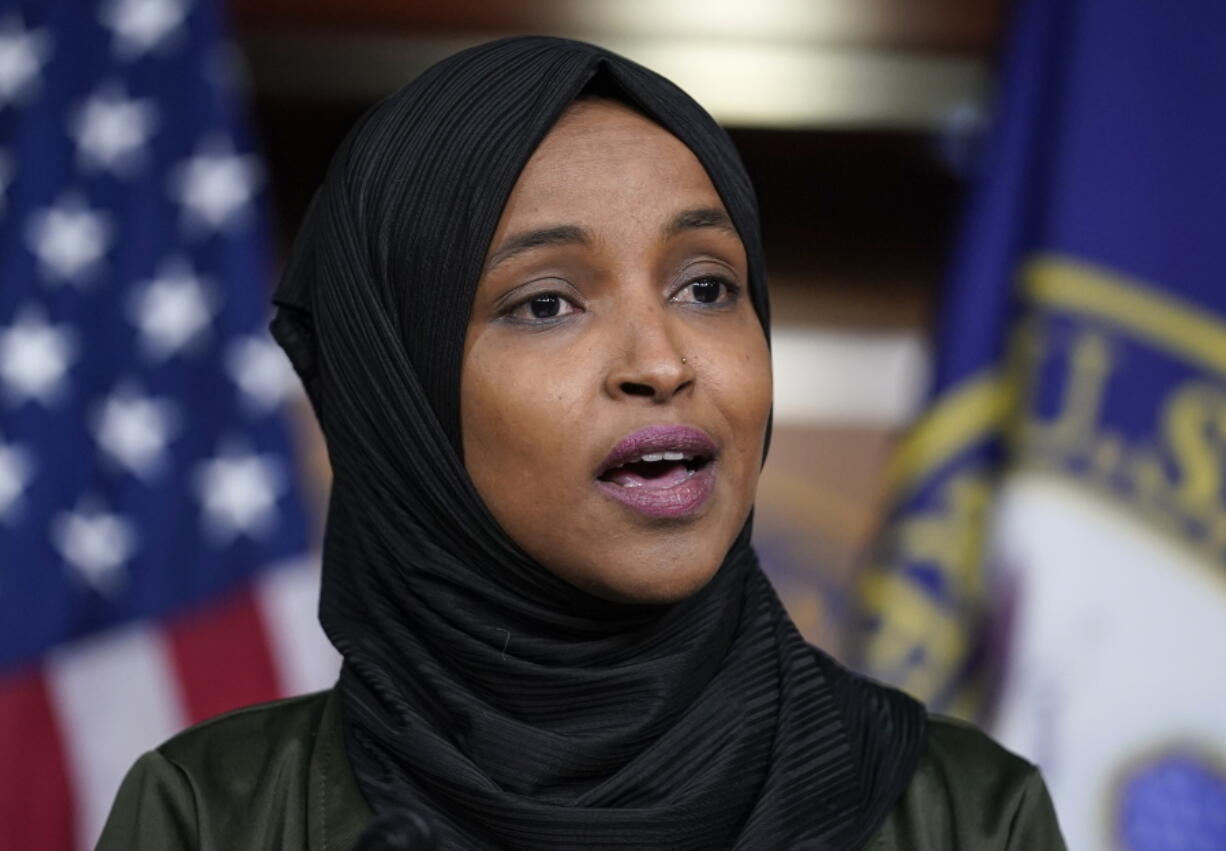 FILE - Rep. Ilhan Omar, D-Minn., speaks to reporters during a news conference at the Capitol in Washington, Nov. 30, 2021. Omar faces a Democratic primary challenger who helped defeat a voter referendum to replace the Minneapolis Police Department with a new Department of Public Safety.(AP Photo/J.
