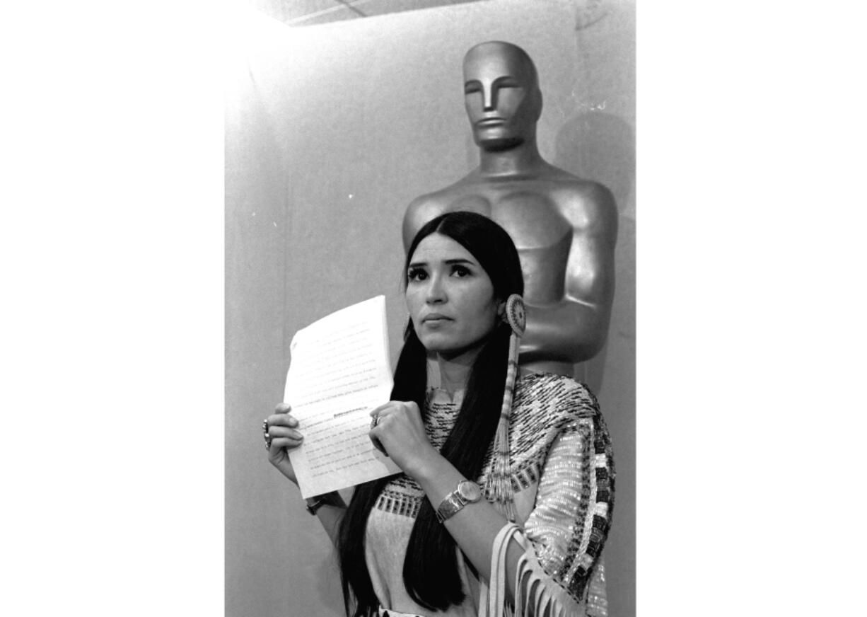 FILE - Sacheen Littlefeather appears at the Academy Awards ceremony to announce that Marlon Brando was declining his Oscar as best actor for his role in "The Godfather," on March 27, 1973. The move was meant to protest Hollywood's treatment of American Indians. Nearly 50 years later, the Academy of Motion Pictures Arts and Sciences has apologized to Littlefeather for the abuse she endured. The Academy Museum of Motion Pictures on Monday said that it will host Littlefeather, now 75, for an evening of "conversation, healing and celebration" on Sept. 17.