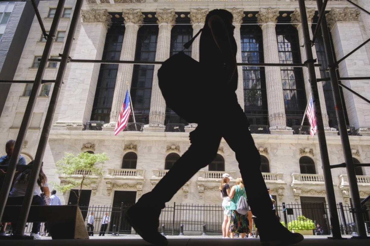 A pedestrian walks past the New York Stock Exchange in New York City, Thursday, Aug. 18, 2022. Major indexes were held back by mostly choppy trading following a weeklong run of gains. (AP Photo/J.