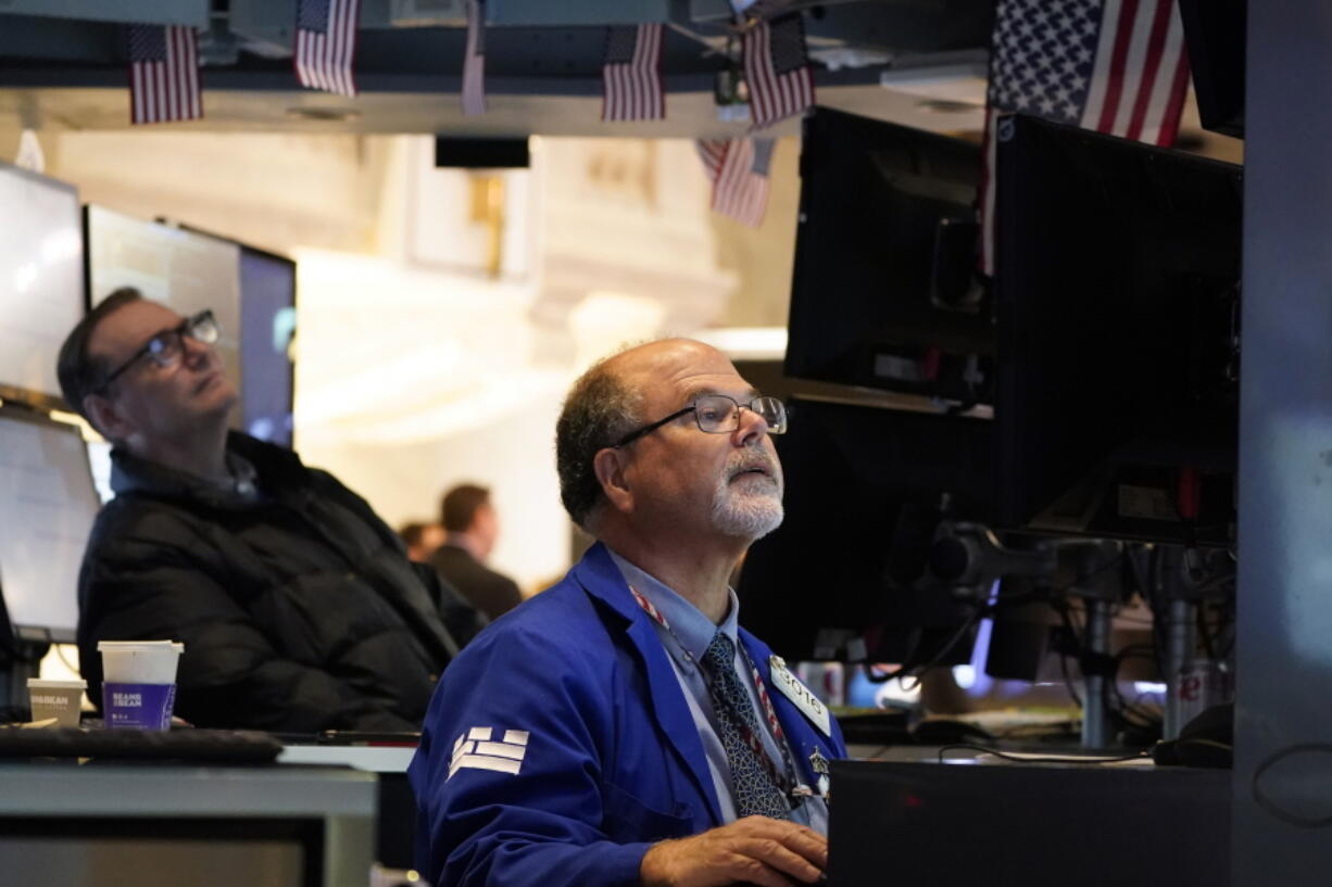 Traders work on the floor at the New York Stock Exchange in New York, Wednesday, Aug. 10, 2022.