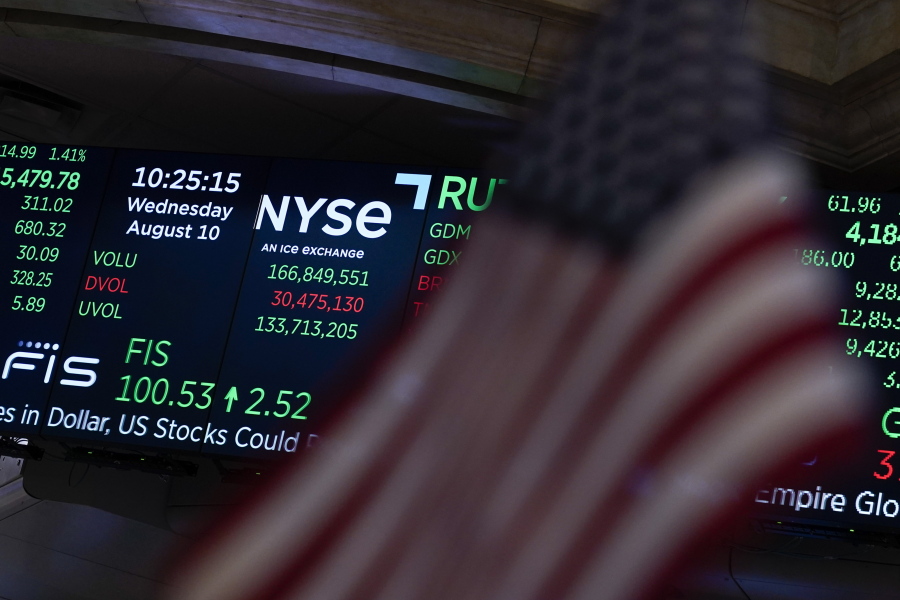 FILE - A screen displays market data at the New York Stock Exchange in New York, Wednesday, Aug. 10, 2022. Stocks are holding steady in the early going on Wall Street, Friday, Aug.