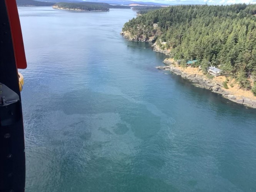 The Saturday, Aug. 13, 2022, aerial photo released by the U.S. Coast Guard shows a diesel spill off the west coast of Washington state's San Juan Island after a 49-foot (15-meter) fishing vessel sank with an estimated 2,600 gallons (9,854 liters) of fuel on board. A Good Samaritan rescued all five crew members on the Aleutian Isle as the vessel was sinking near Sunset Point, the Coast Guard's 13th District Pacific Northwest district in Seattle and KIRO-TV reported. (U.S.