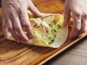 Assembling a chicken caesar wrap isn't hard to do -- just be sure not to overfill it.