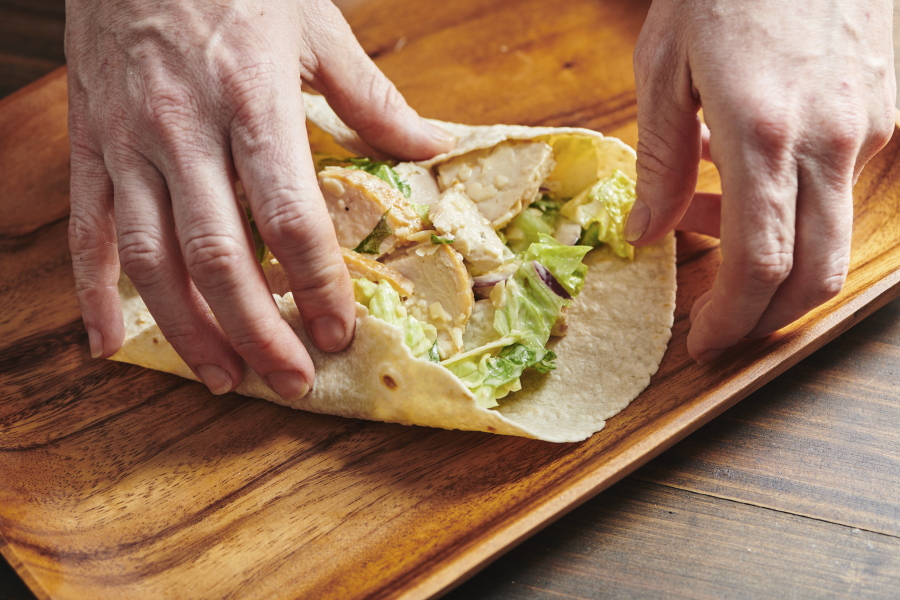 Assembling a chicken caesar wrap isn't hard to do -- just be sure not to overfill it.